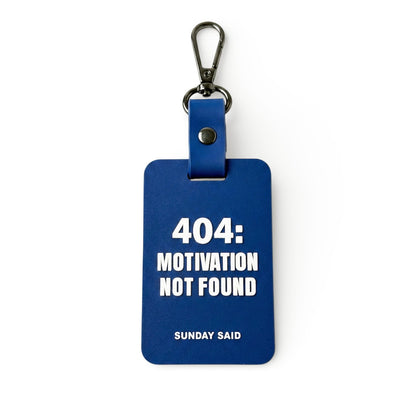Blue 404 Error bag charm with funny Motivation Not Found text. Relatable corporate humor gift for coworkers and tech workers by Sunday Said.