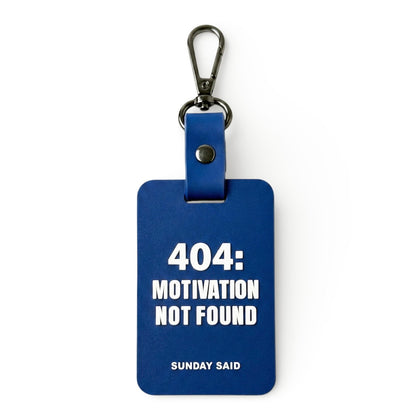 Blue 404 Error bag charm with funny Motivation Not Found text. Relatable corporate humor gift for coworkers and tech workers by Sunday Said.