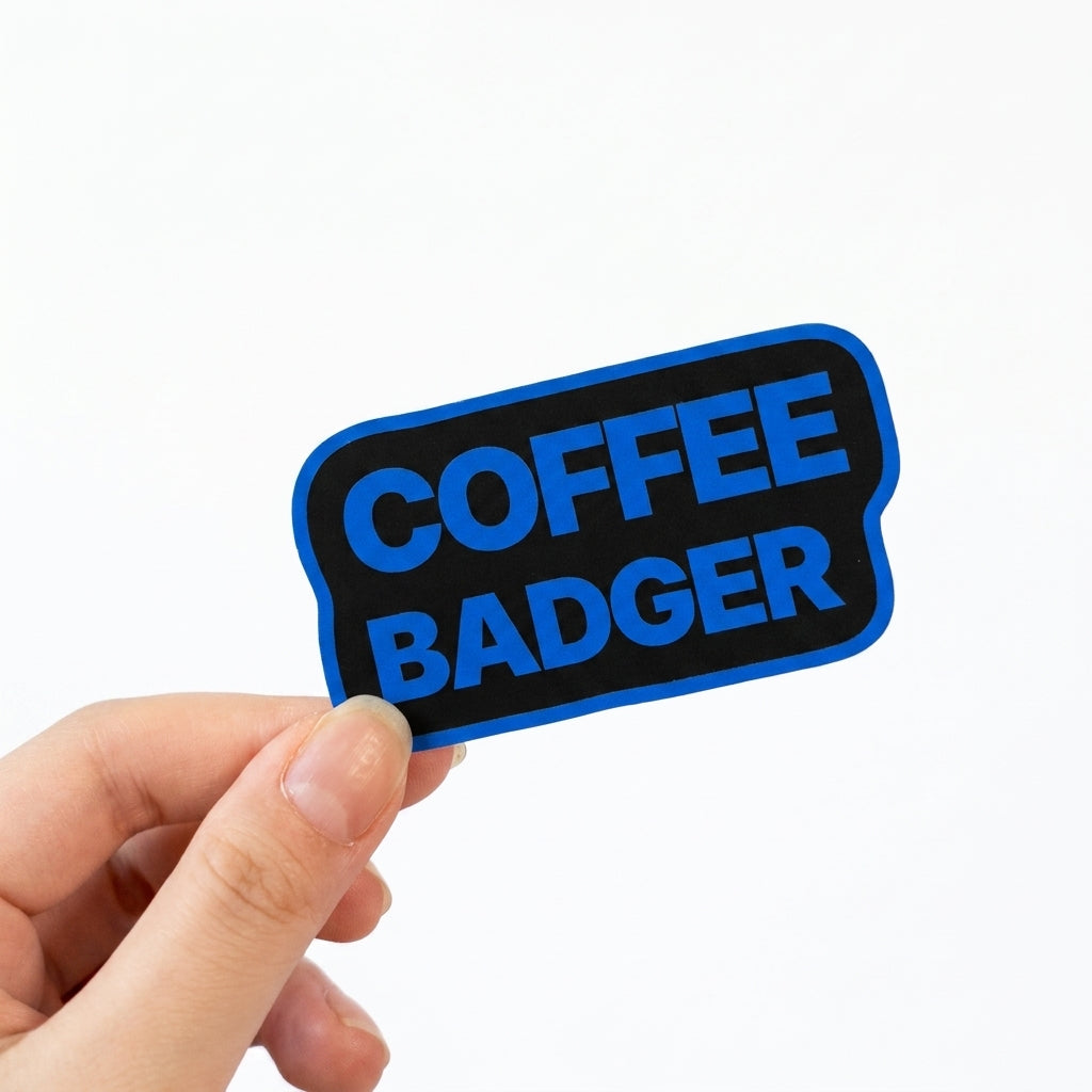 Black and blue Sunday Said sticker with bold text reading “Coffee Badger.”