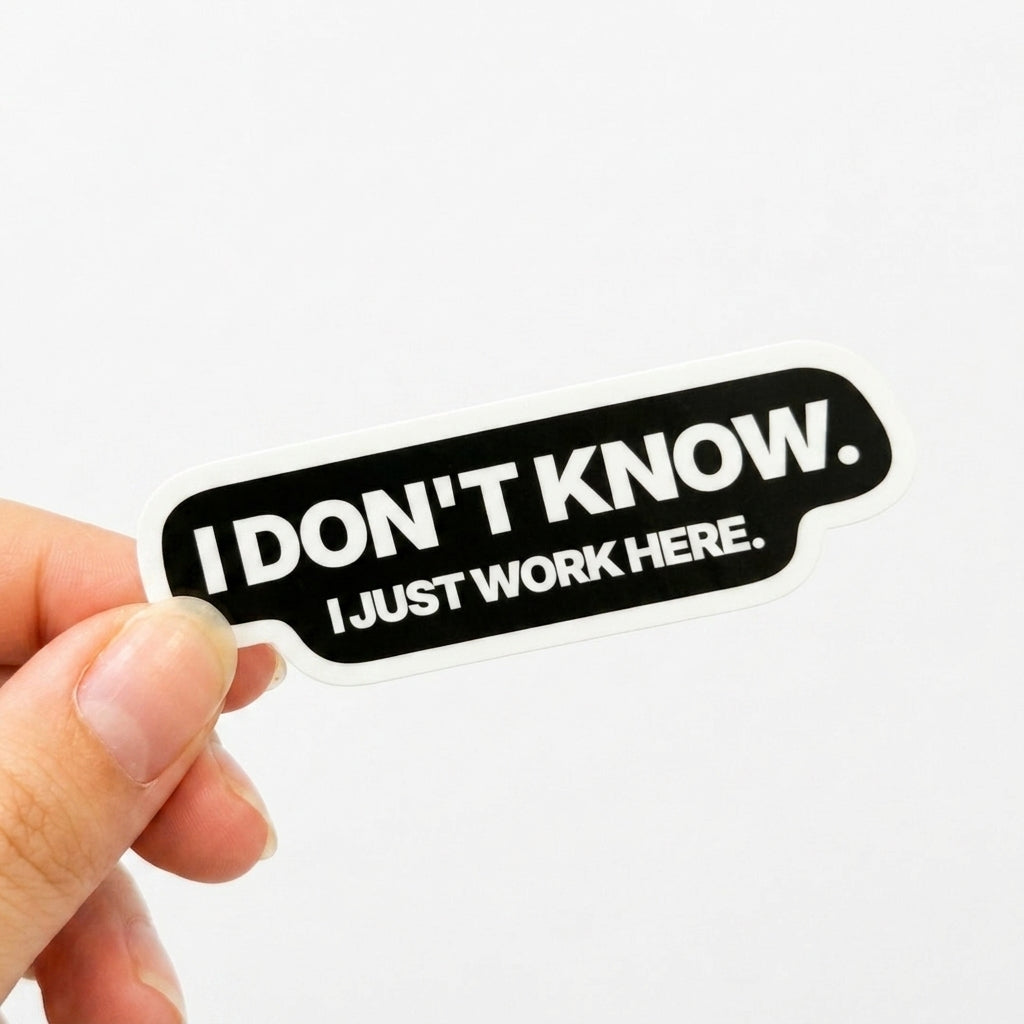 Black corporate survival sticker with white text reading “I don’t know. I just work here.”