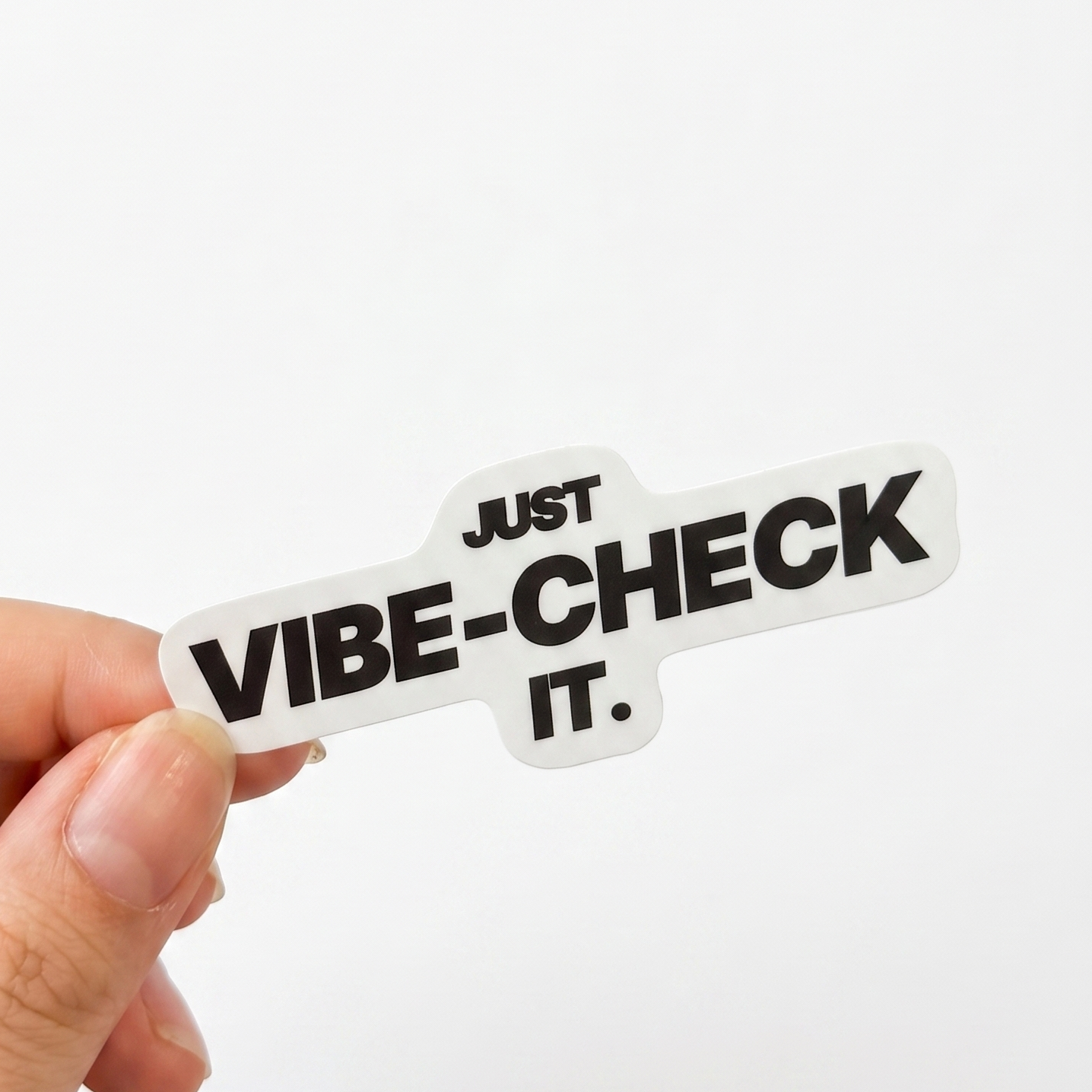 White corporate humor sticker with black text reading “Just vibe-check it.”