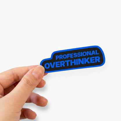 Black office humor sticker with blue text reading “Professional Overthinker.”