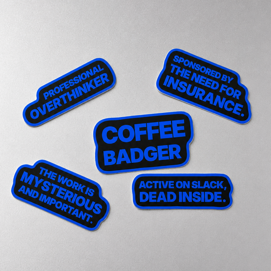 Five black and blue Sunday Said workplace stickers on a silver-gray background with phrases about Slack, coffee, overthinking, insurance, and mysterious work.
