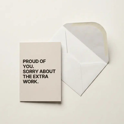 Greeting card with text 'Proud of you. Sorry about the extra work.' on a beige background