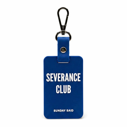 Blue Severance Club bag charm with bold white text. Funny corporate layoff gift and resilience keychain. Sunday Said silicone bag accessory.