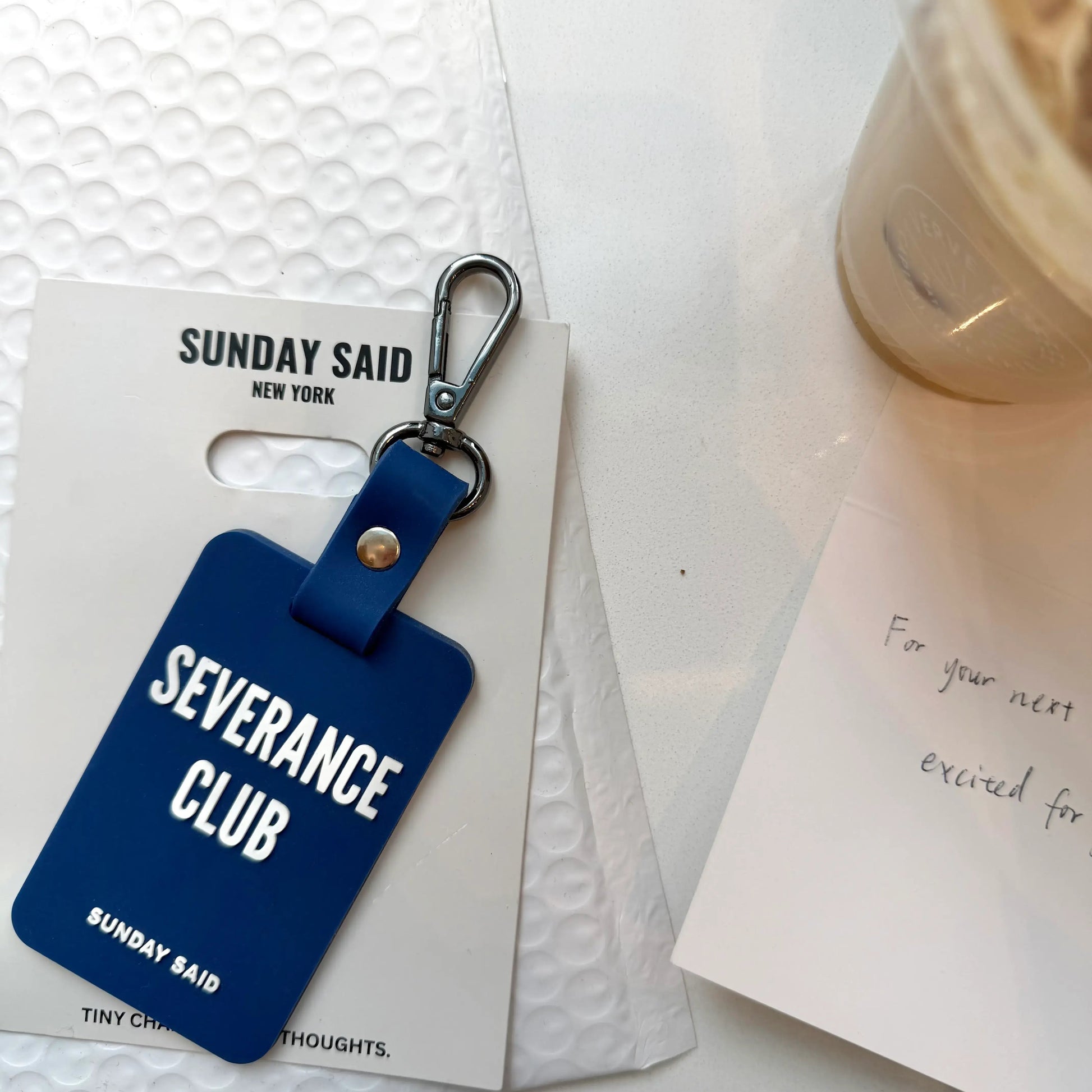 Blue keychain with 'Severance Club' text on a white background