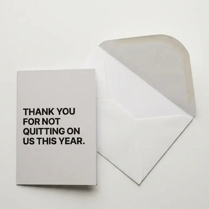 Greeting card with 'Thank you for not quitting on us this year' text on a white background