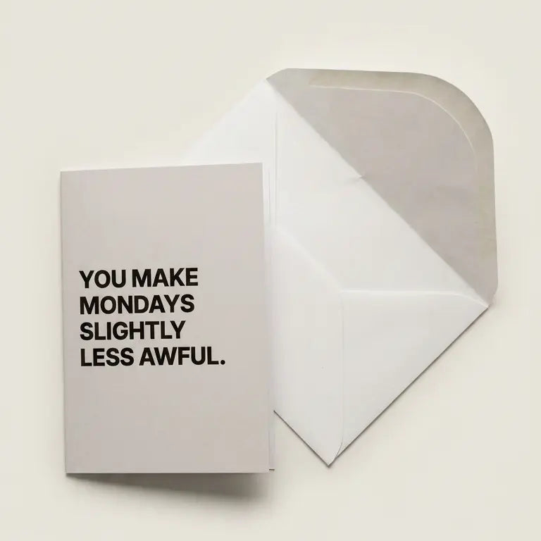 Greeting card with text 'You make Mondays slightly less awful' on a beige background