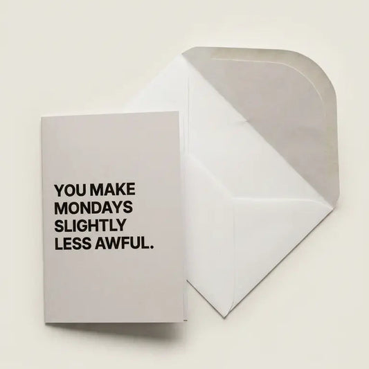 Greeting card with text 'You make Mondays slightly less awful' on a beige background